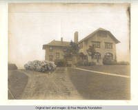 Grey house front entrance with drive
