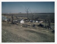 Junkyard of cars by field
