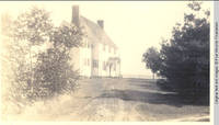 White house with dirt lane