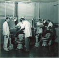 Dental students working with patients in a clinic, The University of Iowa, January 18, 1950