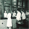 Students at pharmacy window, The University of Iowa, 1940s