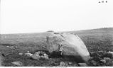 Child near boulder in field, Newton Township, Iowa, late 1890s or early 1900s