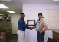 2001  Terrance Rudolph, District Conservationist,  presents Steve Nunnikhoven with a certificate for 2001 Woodland Owner of the Year
