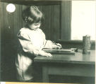 Girl writes with a battery powered tablet, The University of Iowa, ca. 1920