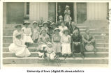 Group posed with baby on Old Capitol steps for reunion, The University of Iowa, 1911