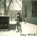Child standing in snow, The University of Iowa, February 22, 1938
