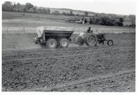 1978 Man on tractor with wagon plants seed