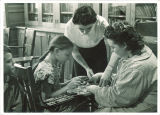 Teachers working with young girl in Perkins School, Children's Hospital, The University of Iowa, November 22, 1940